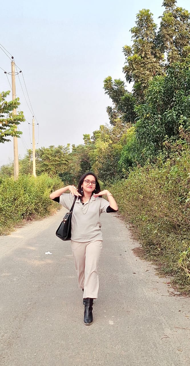 Drisana walking outdoors on a path surrounded by greenery
